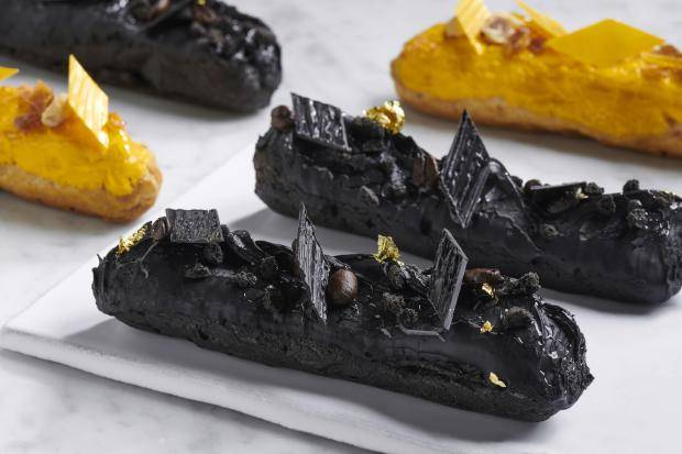 Black themed éclairs with decorations